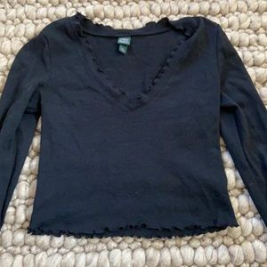 Black cropped long sleeved tee. Black has rufffles